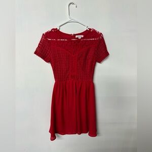 Short red dress with lace detail.